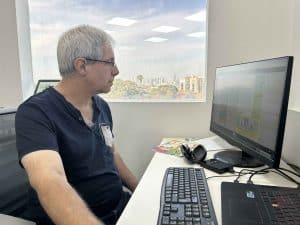 רמי שיר, העורך הראשי והבעלים של הוצאת אצבעוני, מעיין בגיליון של עיתון הילדים "אצבעוני" בספריית המערכת.